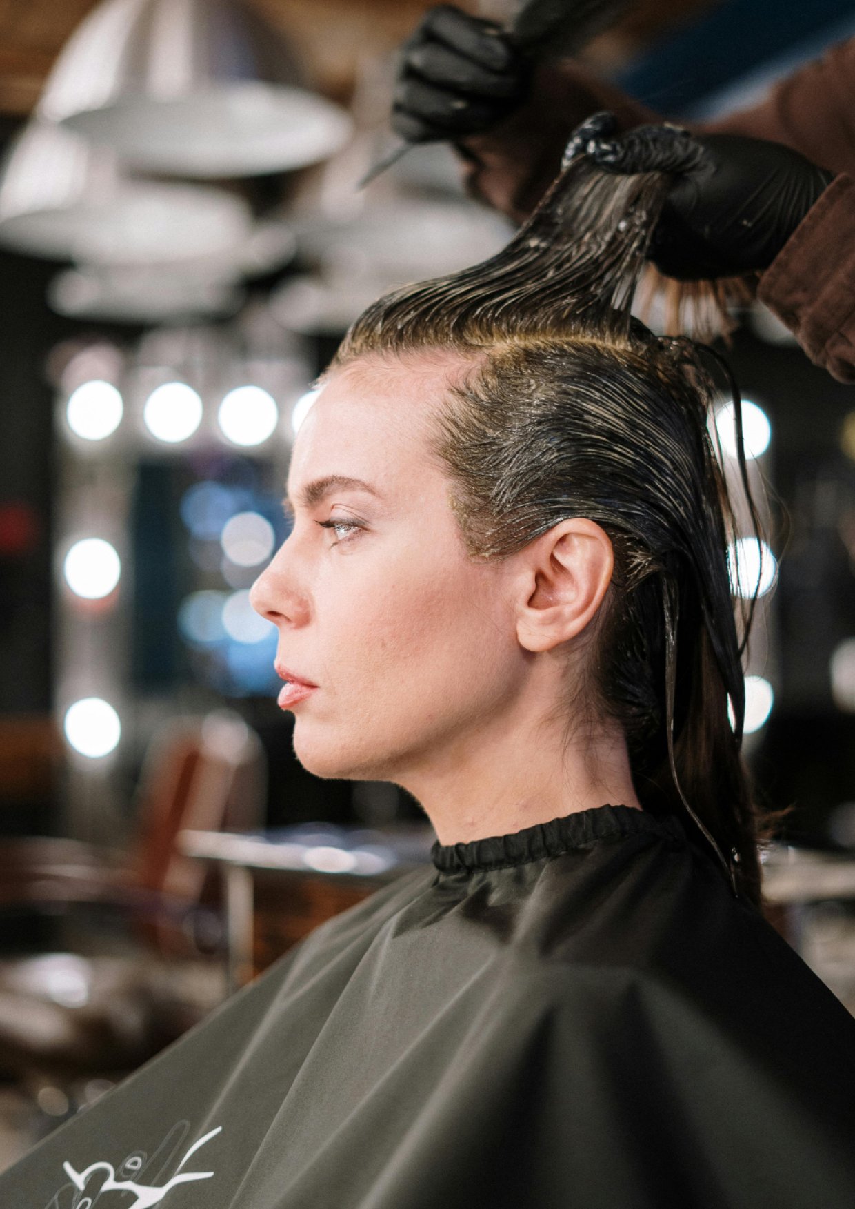 Stylist working on client's hair