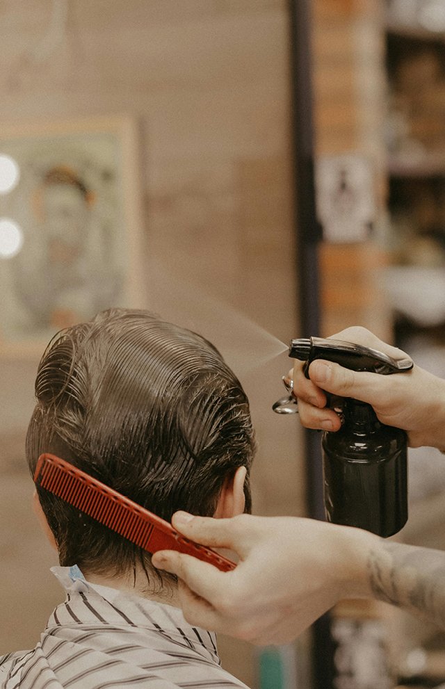 Stylist working on client's hair